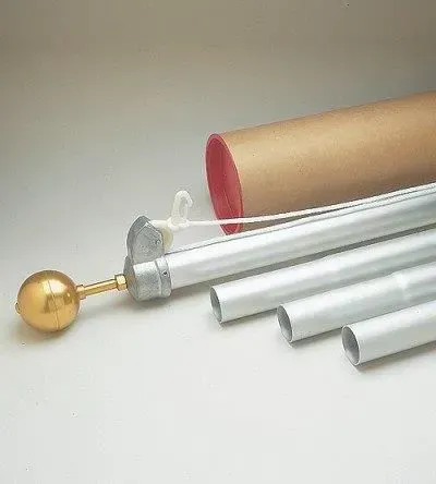 Disassembled silver aluminum flagpole with gold ball finial and a cardboard tube on white background.