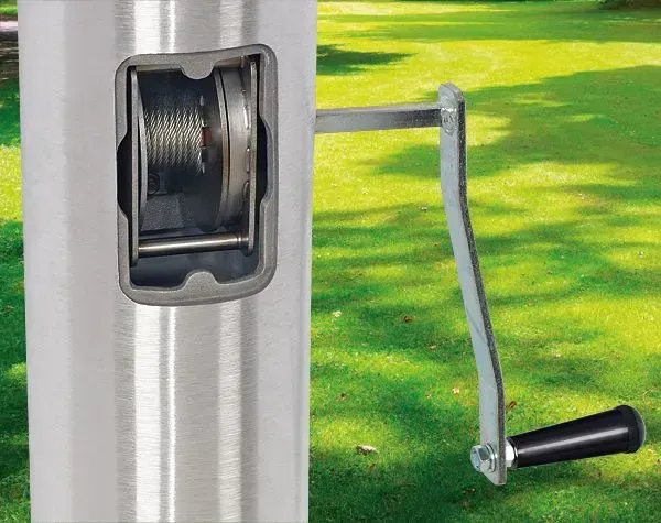 Metal pole with a crank mechanism to raise or lower something, possibly an umbrella, outdoors.