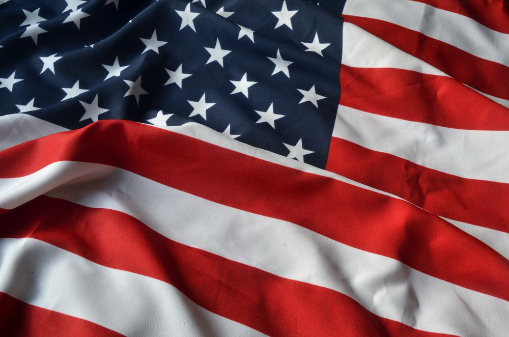 American flag, red and white stripes, blue field with white stars.