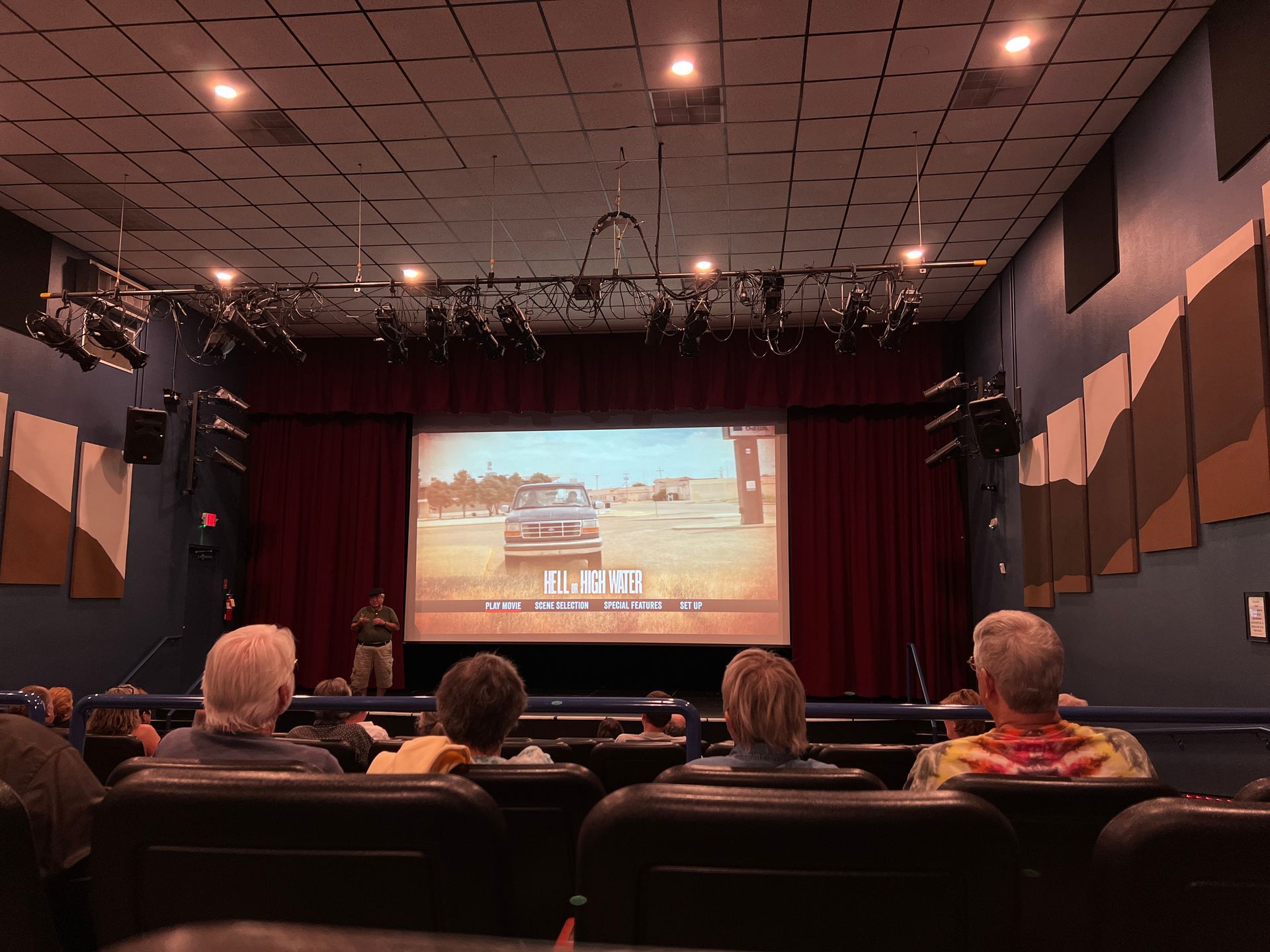 A group of people are watching a movie in a theater.