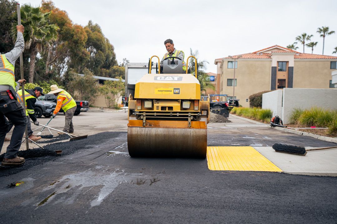 A group of construction workers are working on a road.