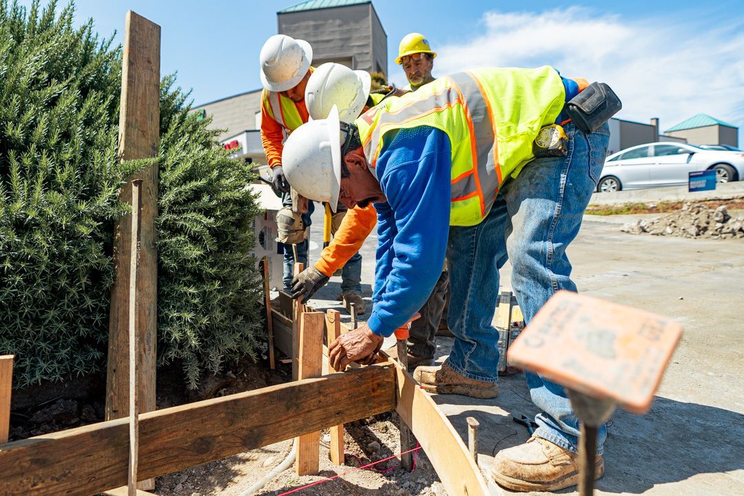 A group of construction workers are working on a construction site.