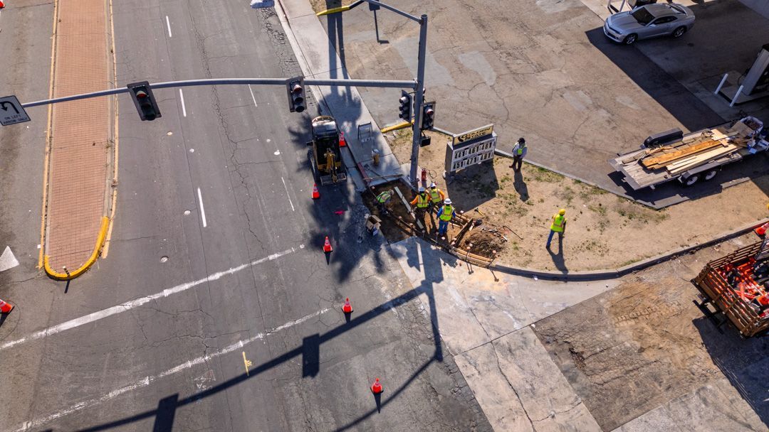 An aerial view of a construction site on the side of a city street.