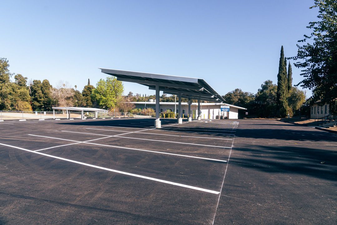 An empty parking lot with a solar panel on top of it.