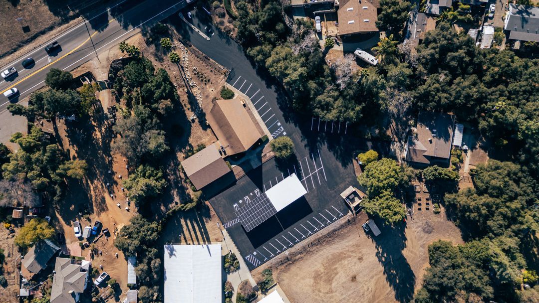 An aerial view of a residential area with a lot of houses and trees.