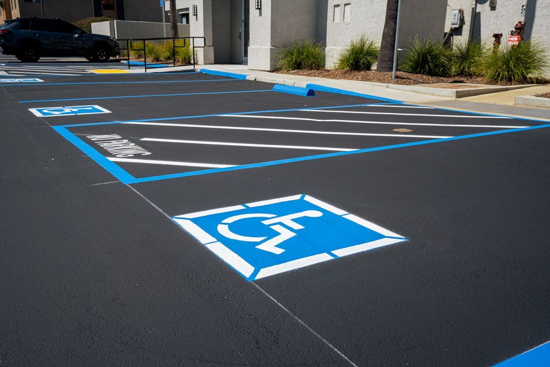 A parking lot with a handicap sign painted on it.