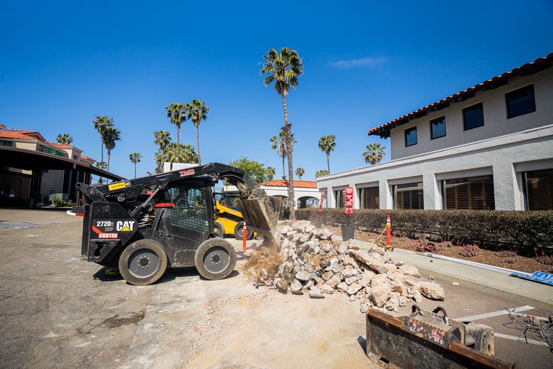 A bulldozer is working on a construction site in front of a building.