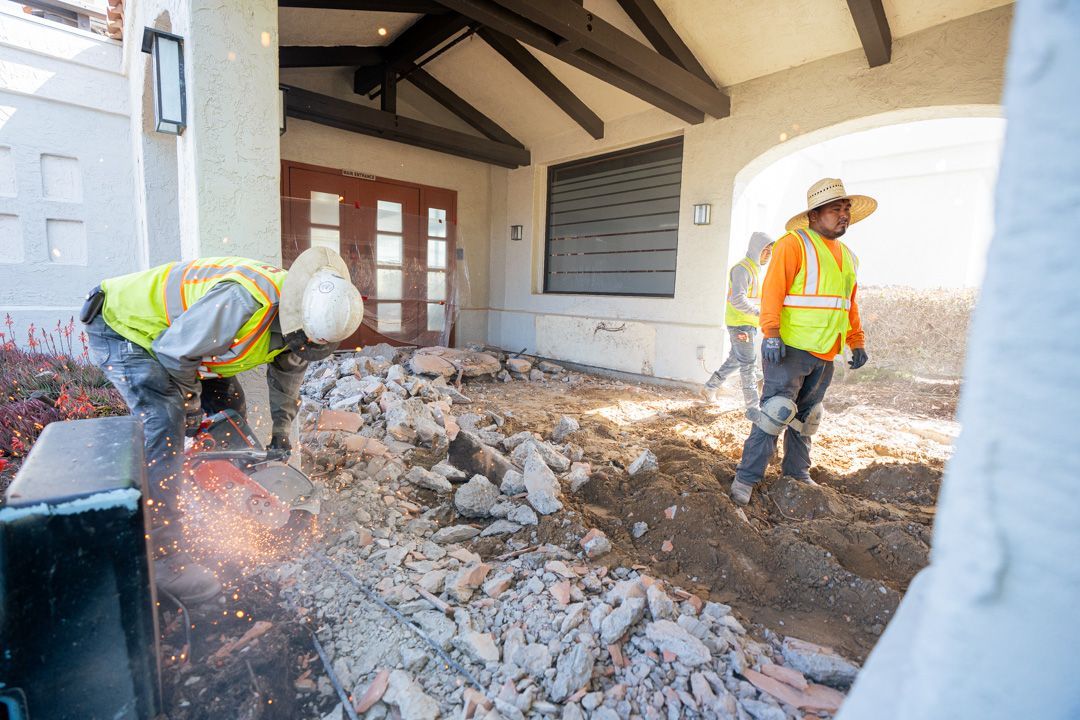 A group of construction workers are working on a building.