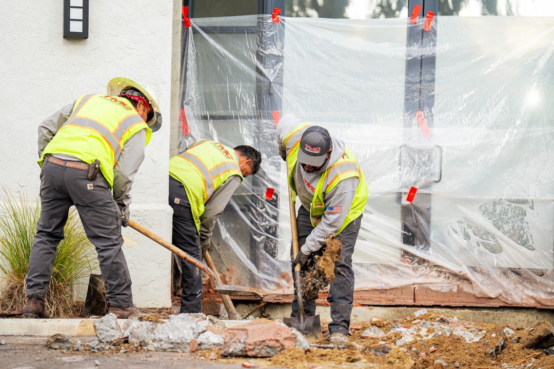 A group of construction workers are working on a building.