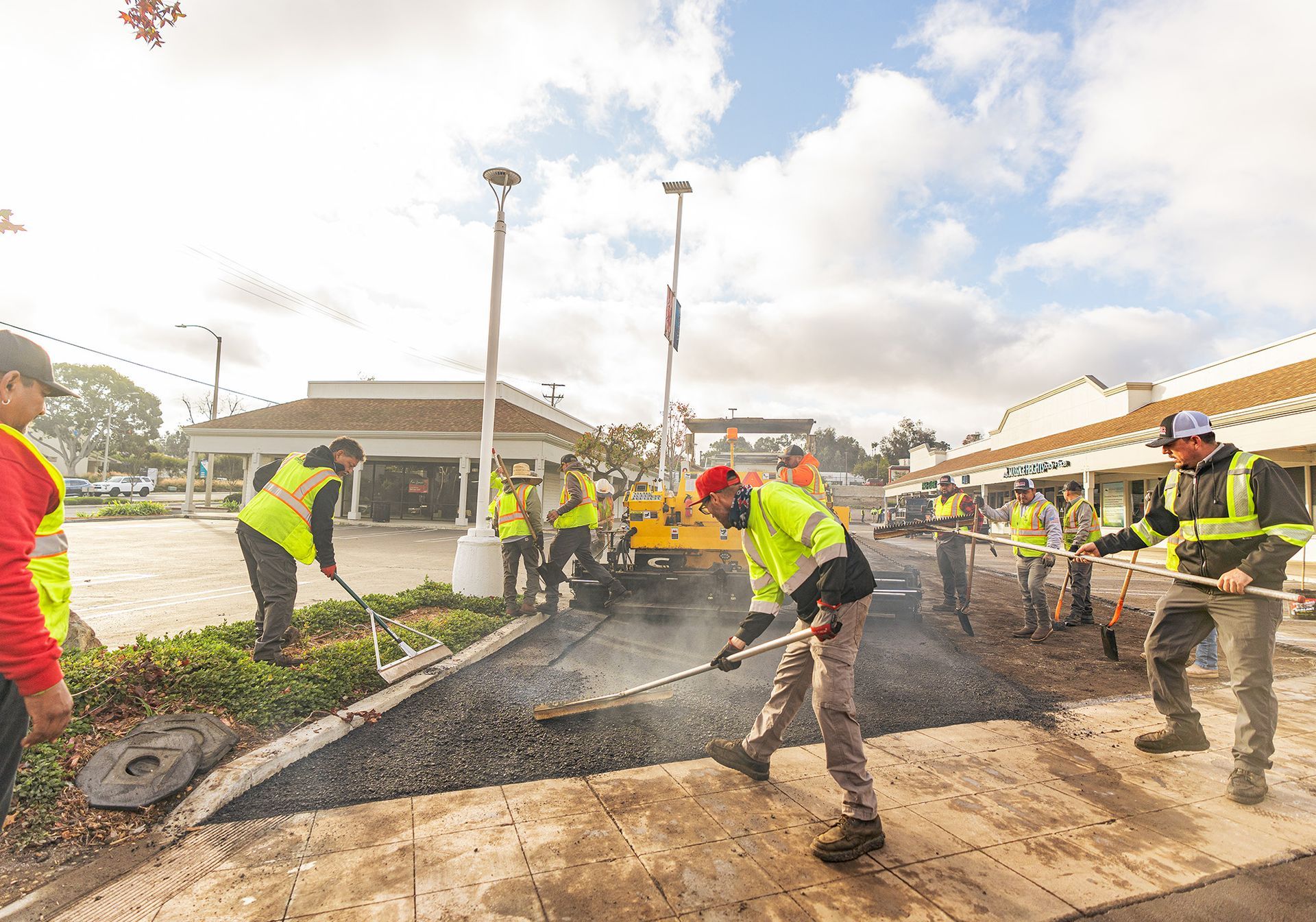 A group of construction workers are working on a road.