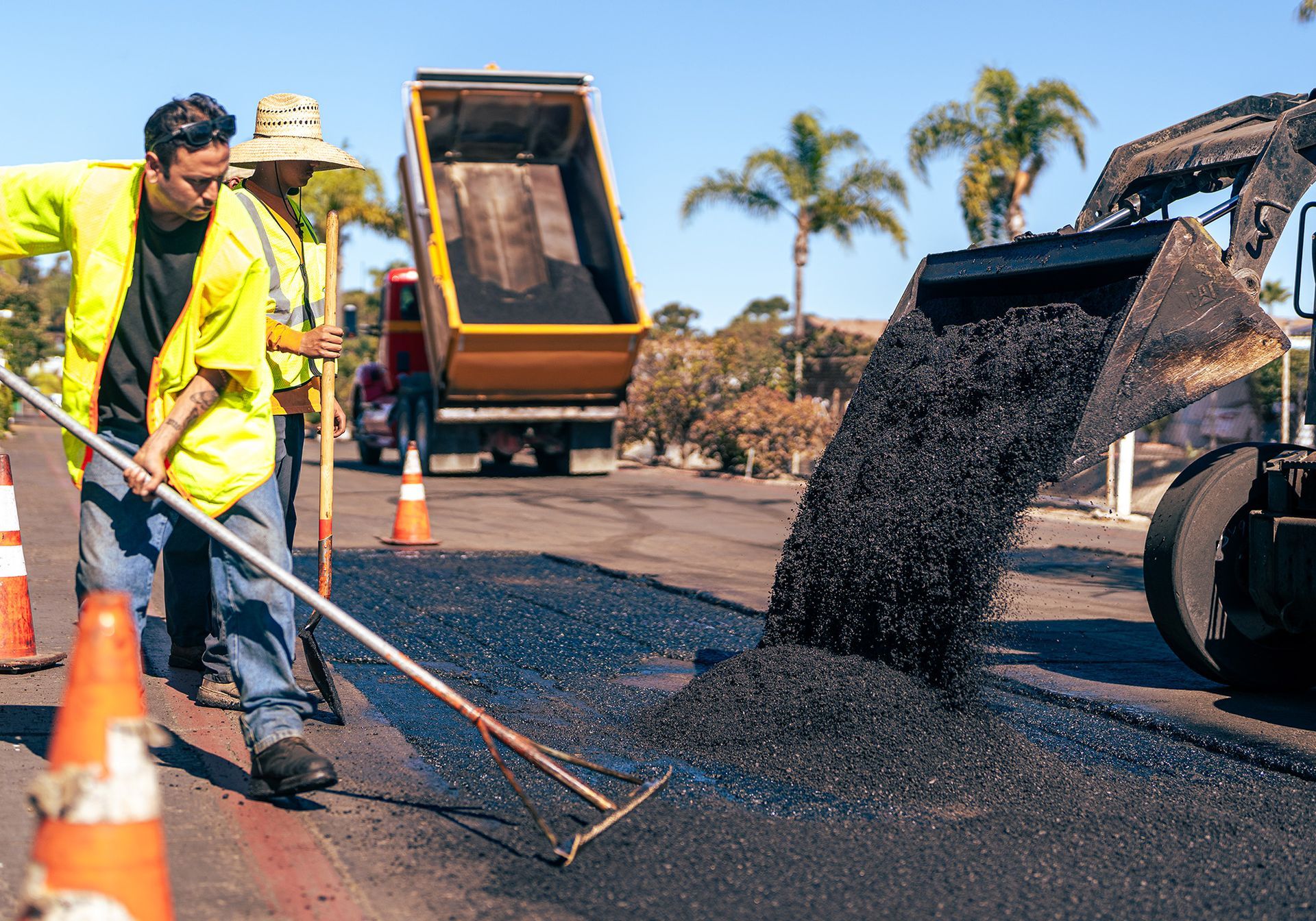 A group of construction workers are working on a road.