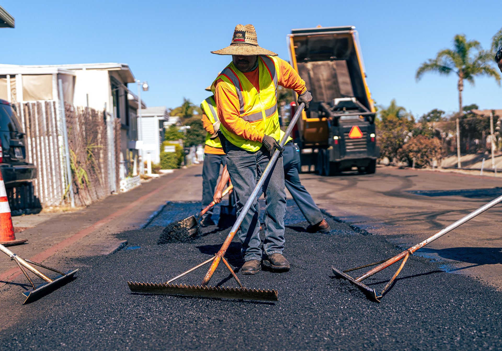 A group of construction workers are working on a road.
