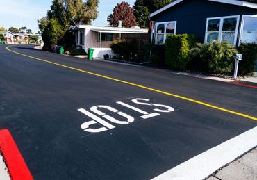 A stop sign is painted on the side of a road