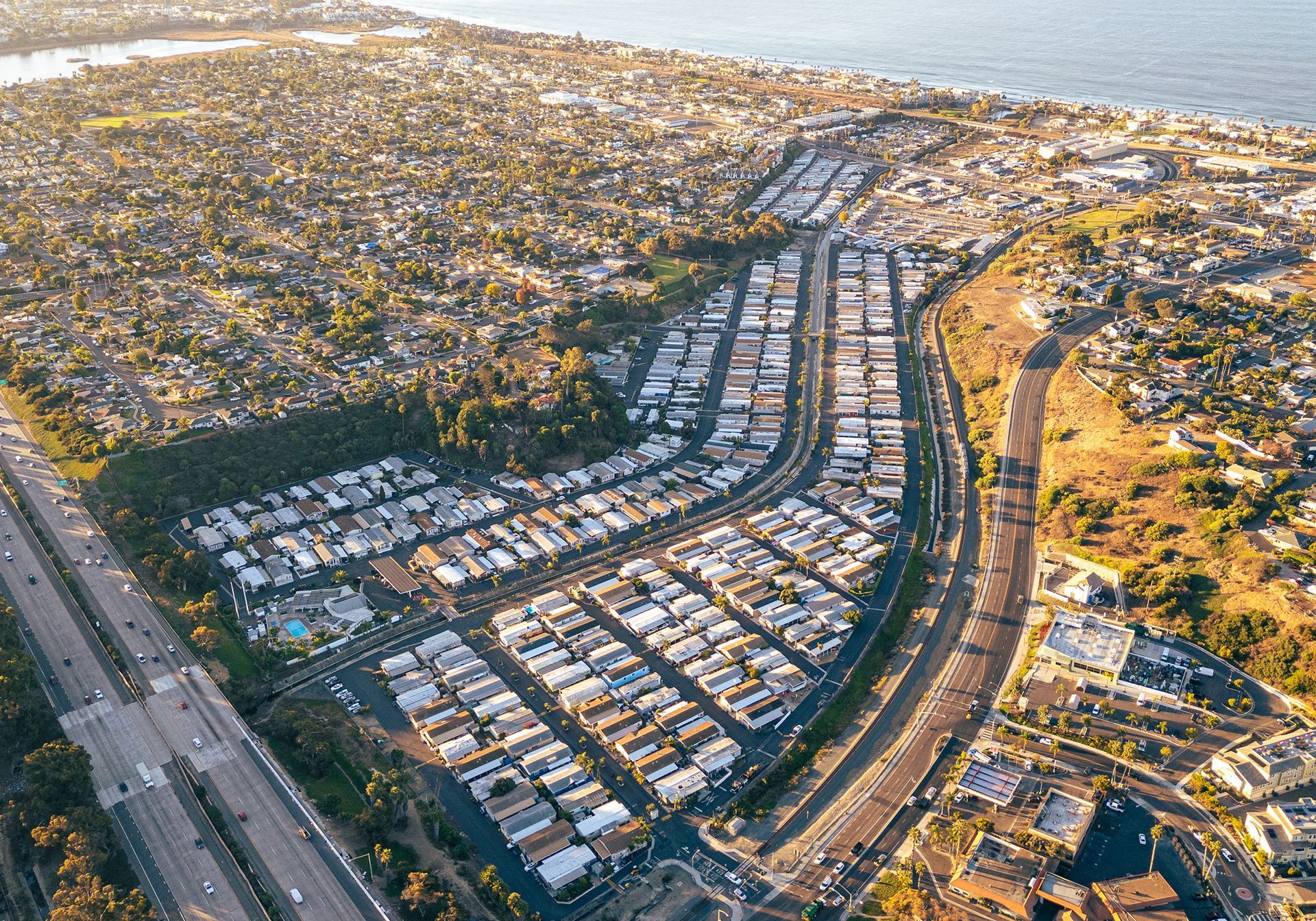 An aerial view of a residential area next to the ocean.