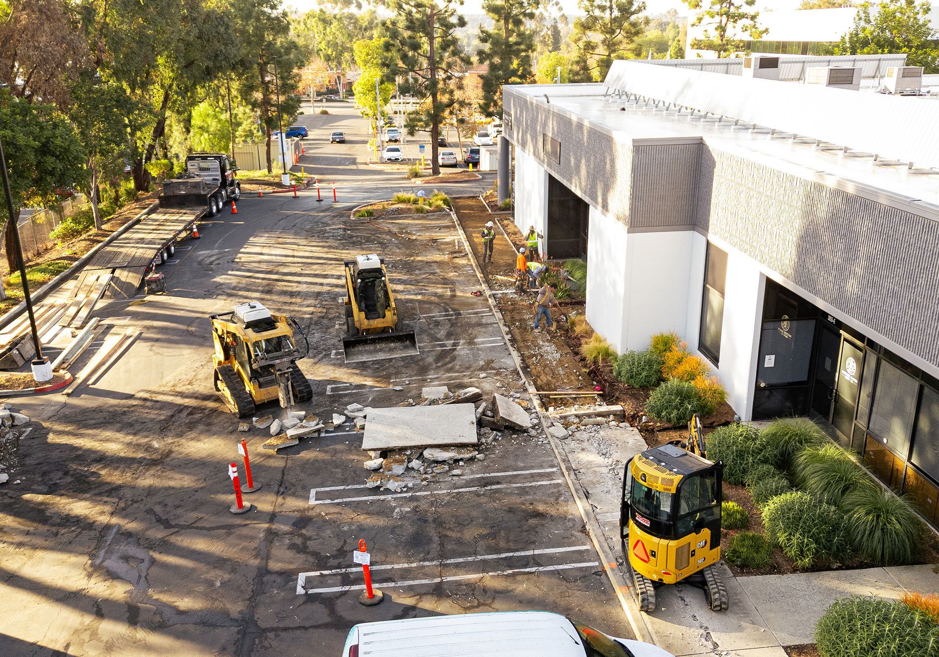 An aerial view of a construction site with a building in the background.