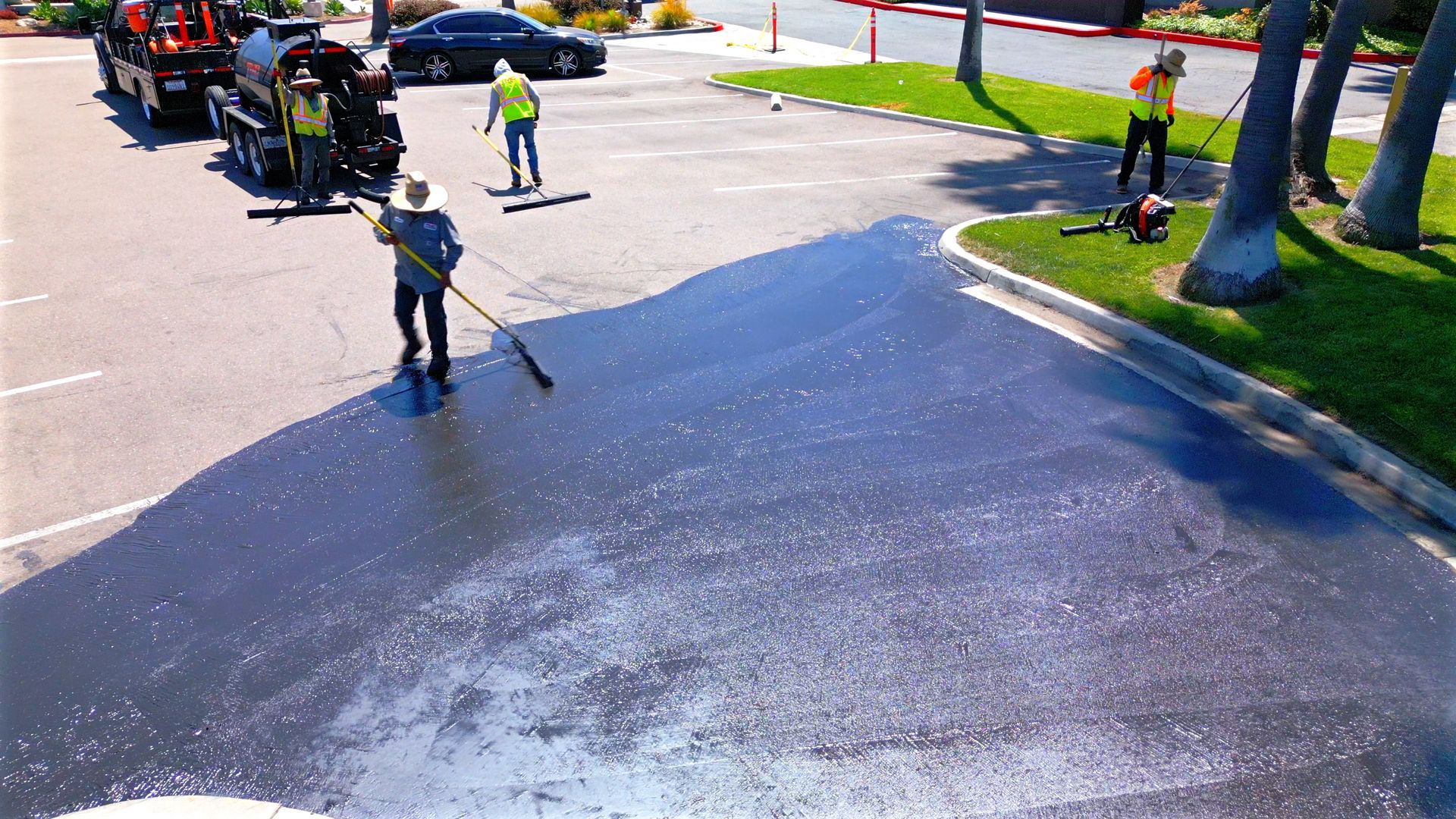A group of people are working on a parking lot.