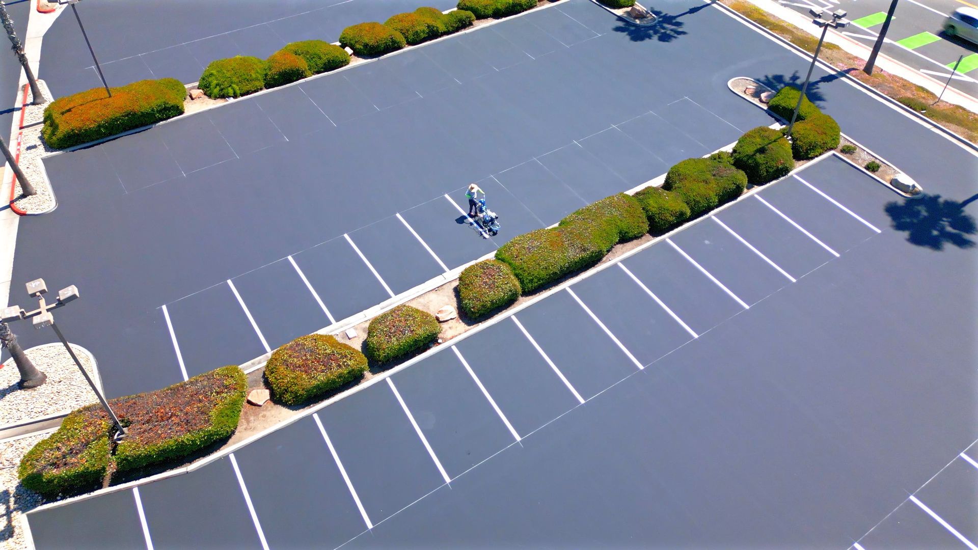A person is riding a bike in a parking lot.