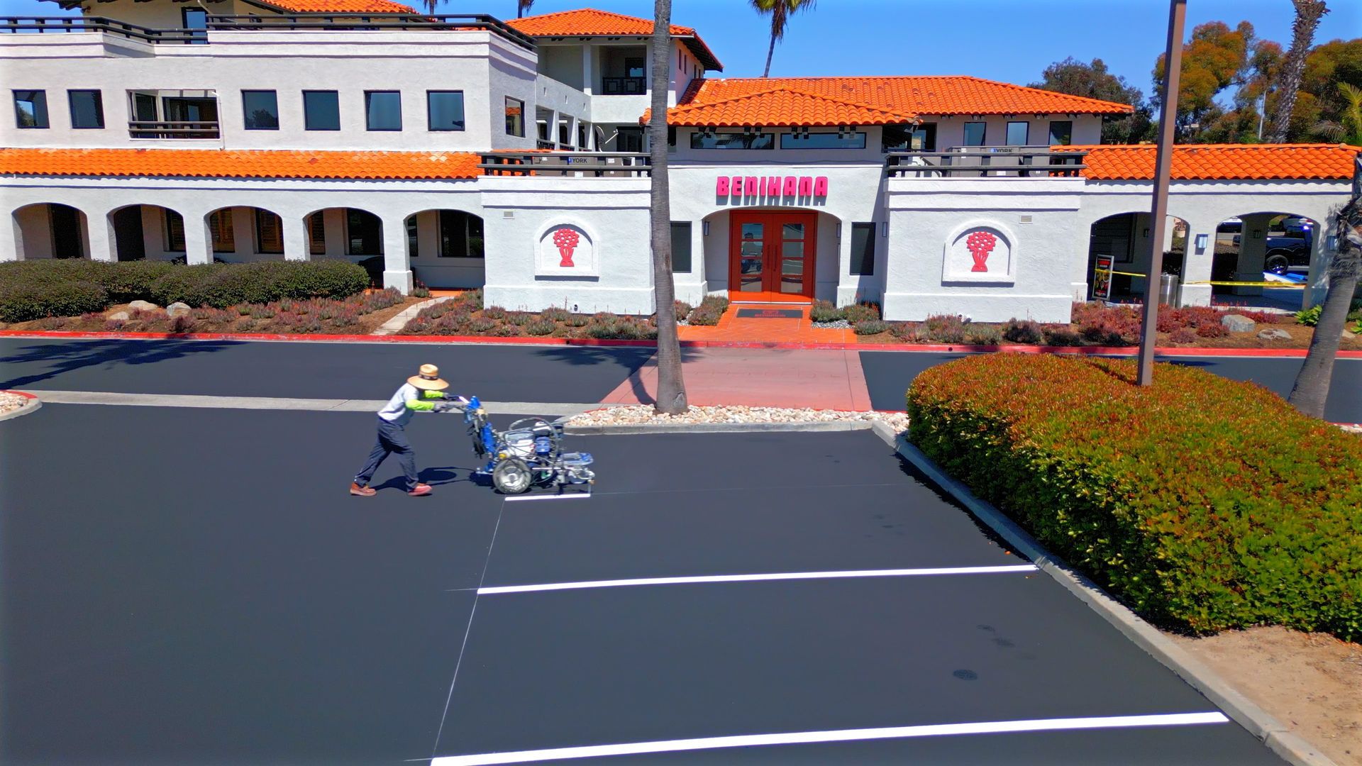 An aerial view of a parking lot in front of a building