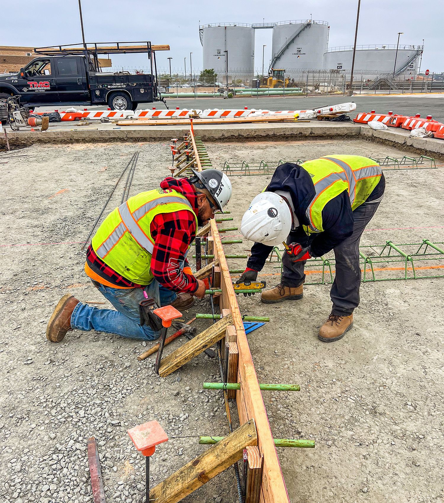 Two construction workers are working on a construction site.