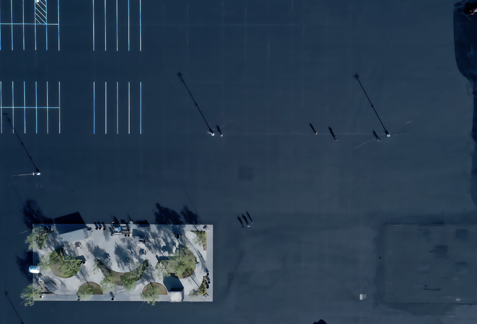 An aerial view of a parking lot with cars parked in it.