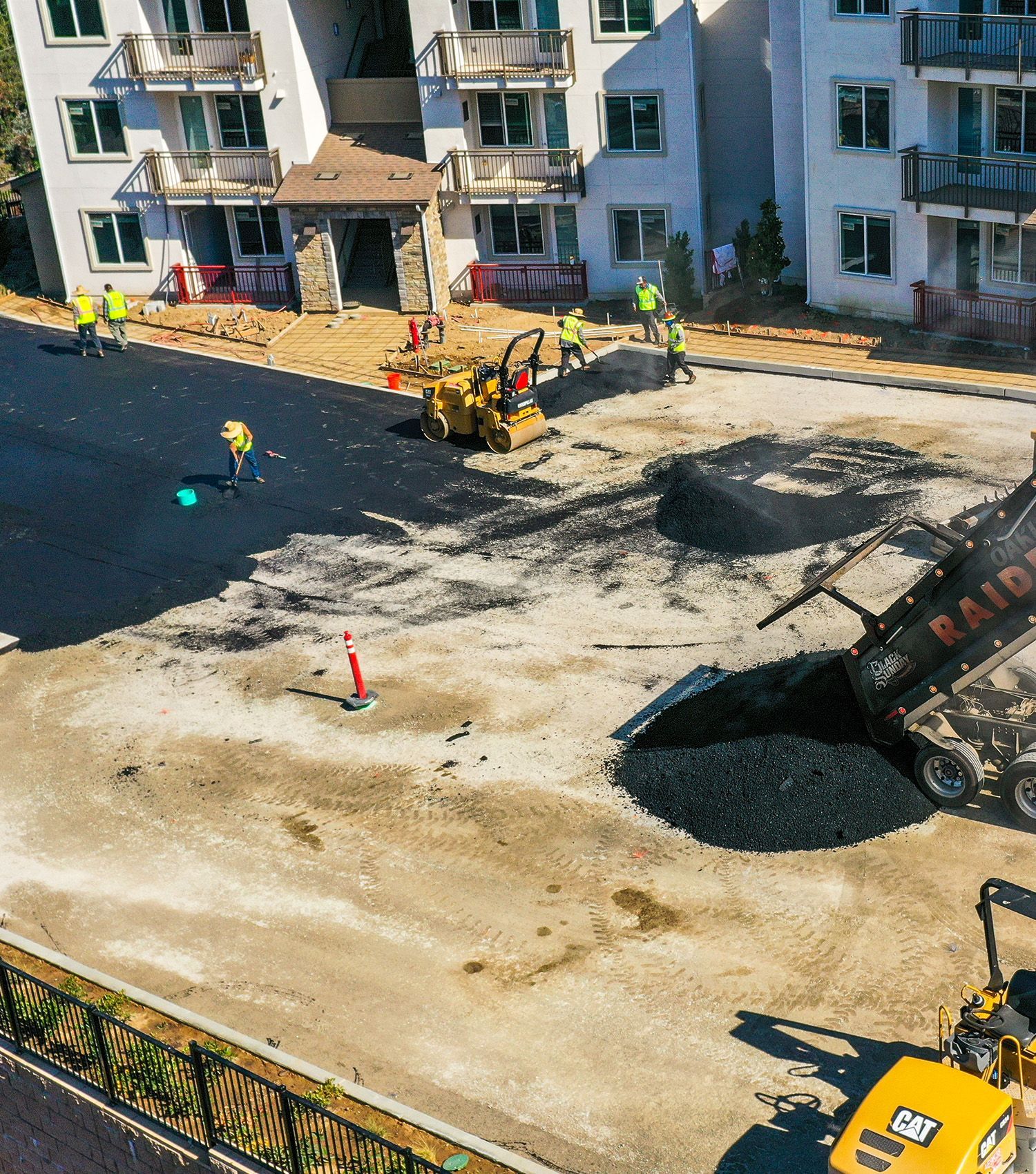 An aerial view of a construction site with a building in the background.