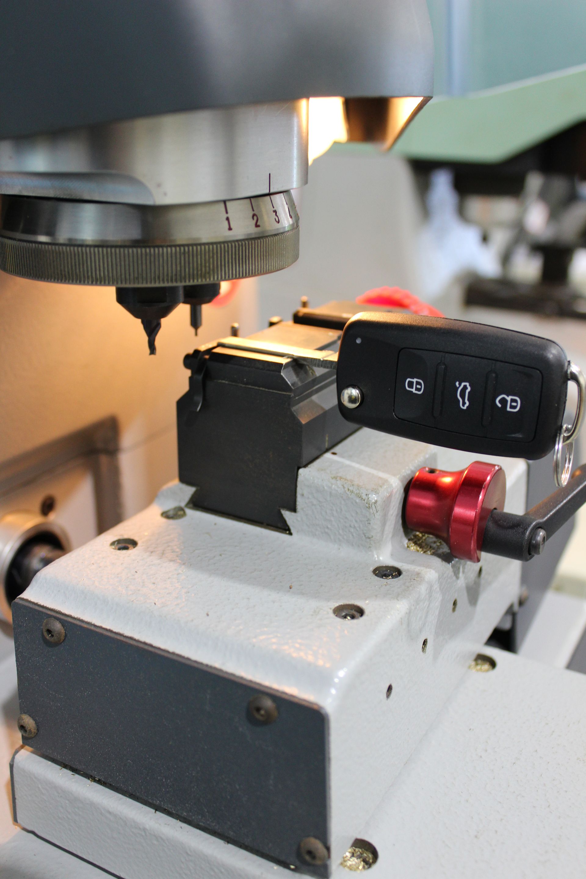 Car Key being cut — Automotive Locksmiths on the Sunshine Coast, QLD