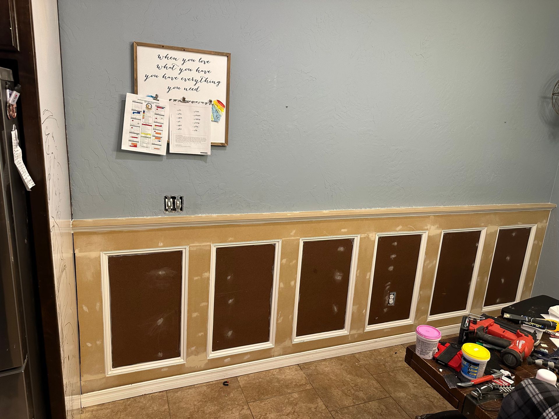 a room with a wooden wall and a white board on the wall .