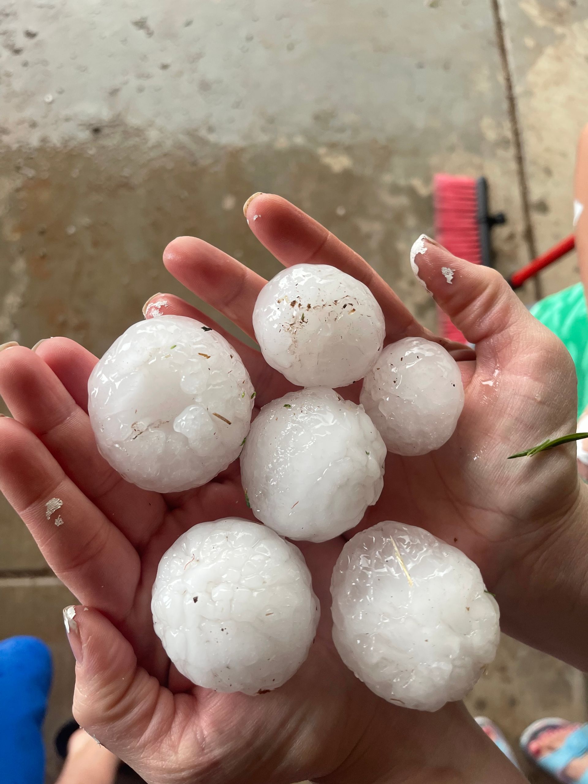 a person is holding a bunch of hail in their hands .