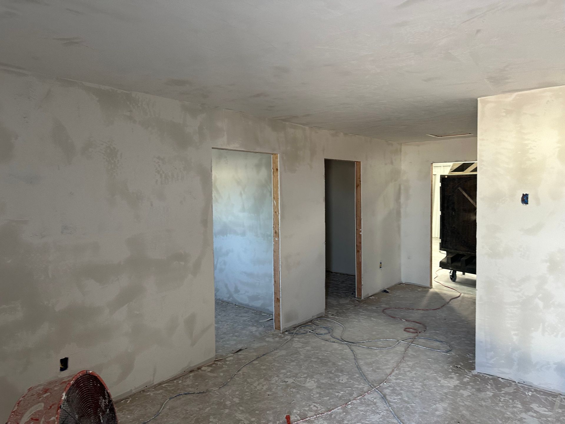 a room with white walls and a door in it