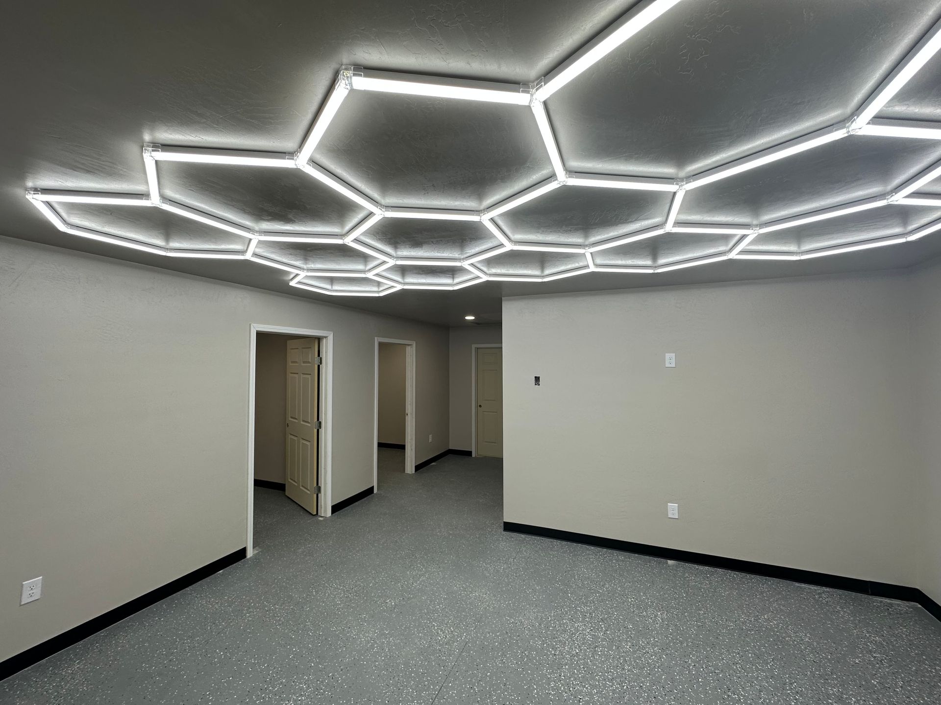 an empty room with a ceiling that looks like a honeycomb .