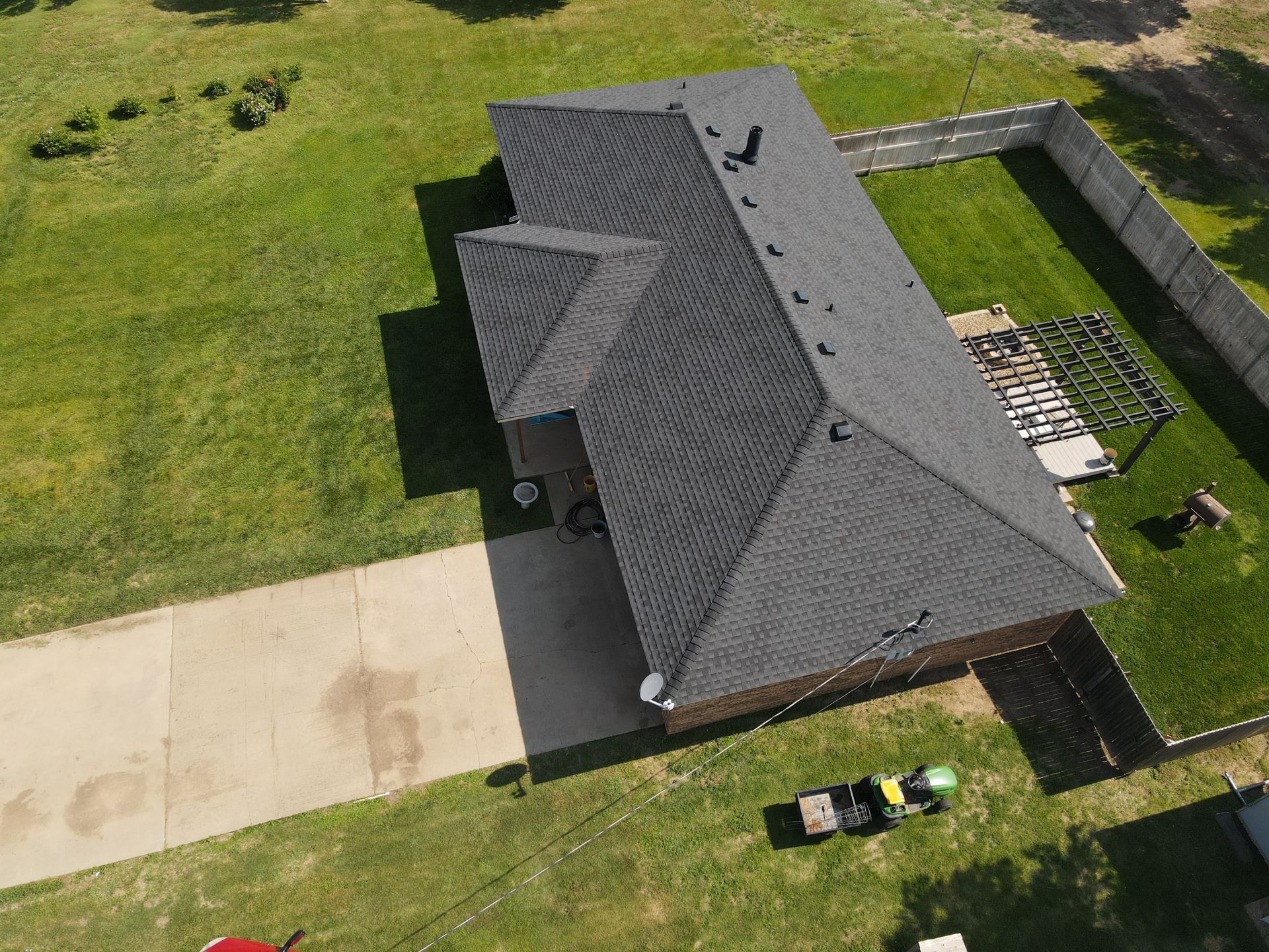 an aerial view of a house with a roof and a driveway .