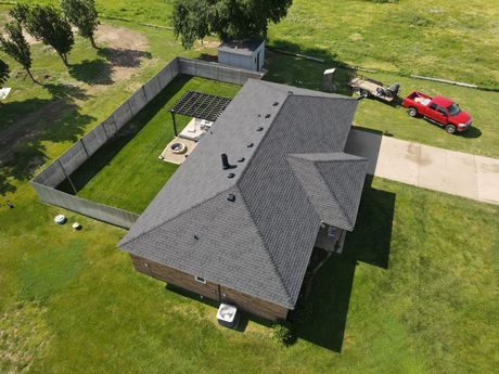 an aerial view of a house with a red truck parked in front of it .