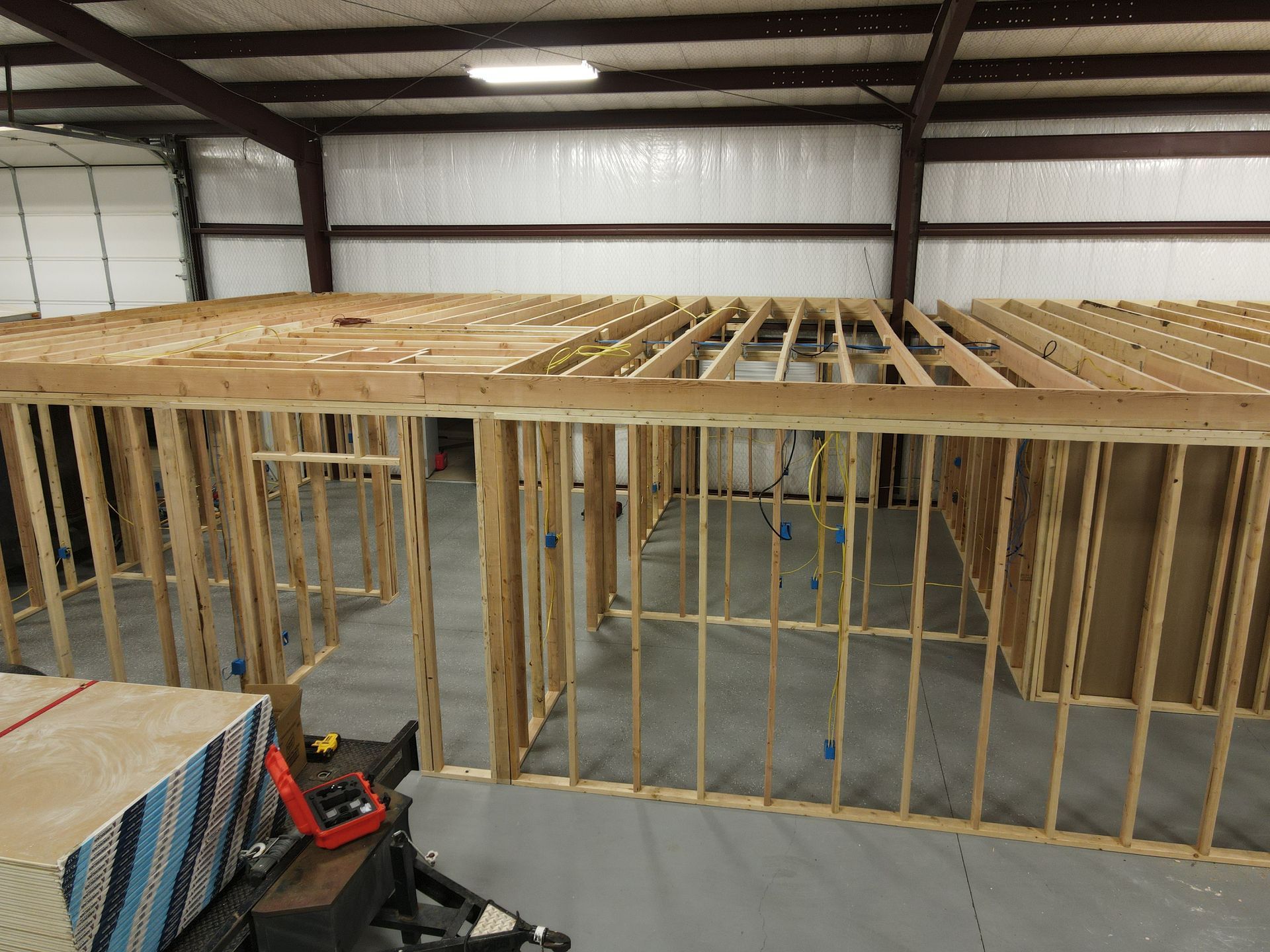 a large wooden structure is being built in a garage .