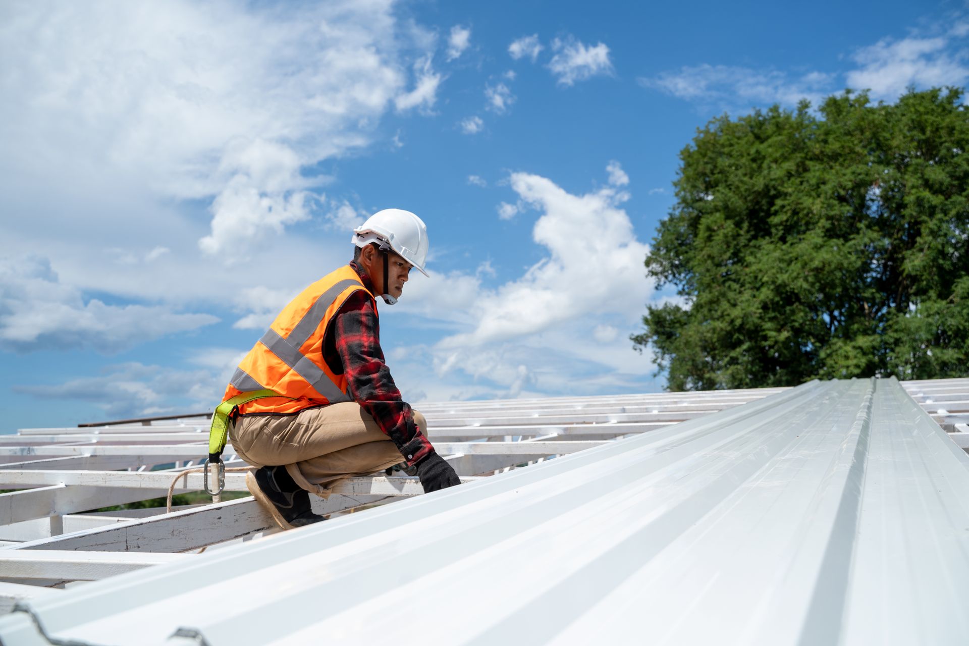 a man is working on the roof of a building .