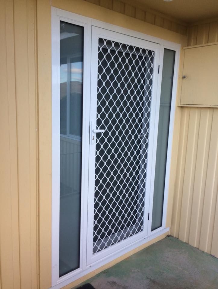A white door with a black mesh screen on it