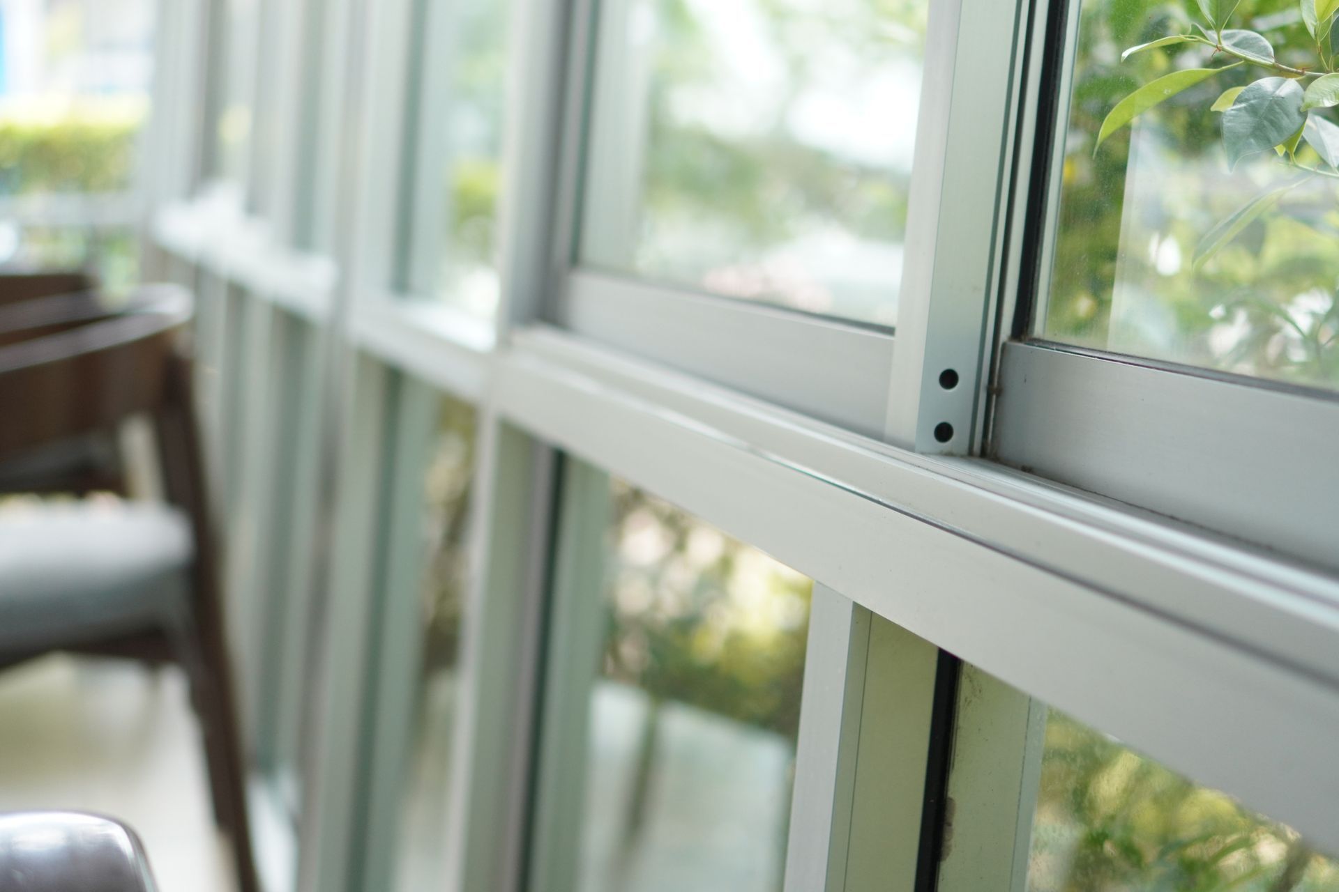 Close-up of an aluminium frame window, facing the outside.