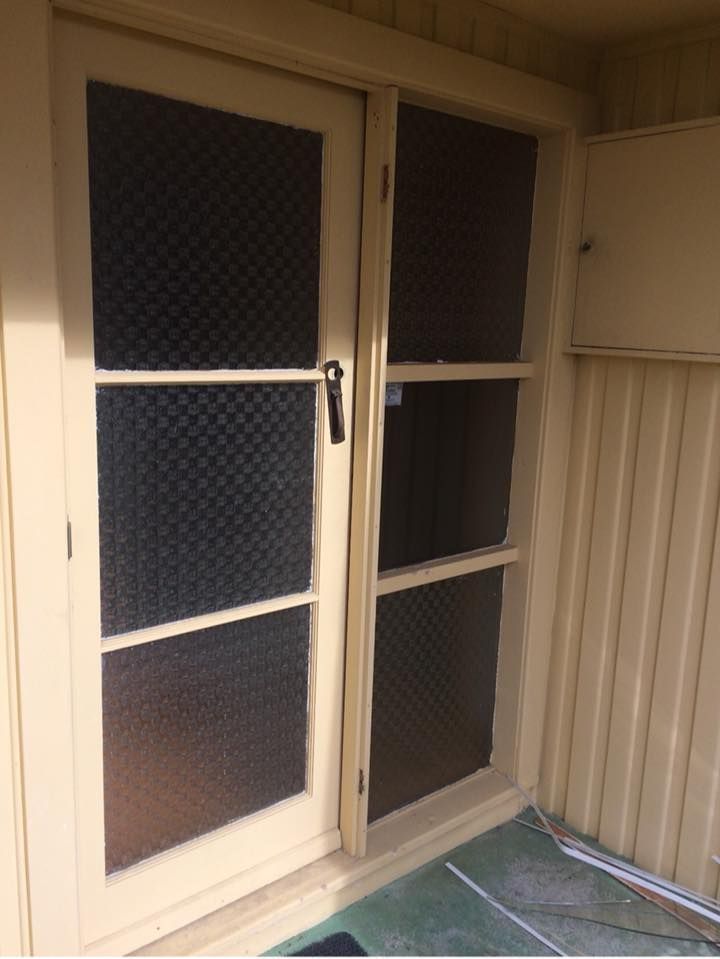 A white door with a mesh screen on it