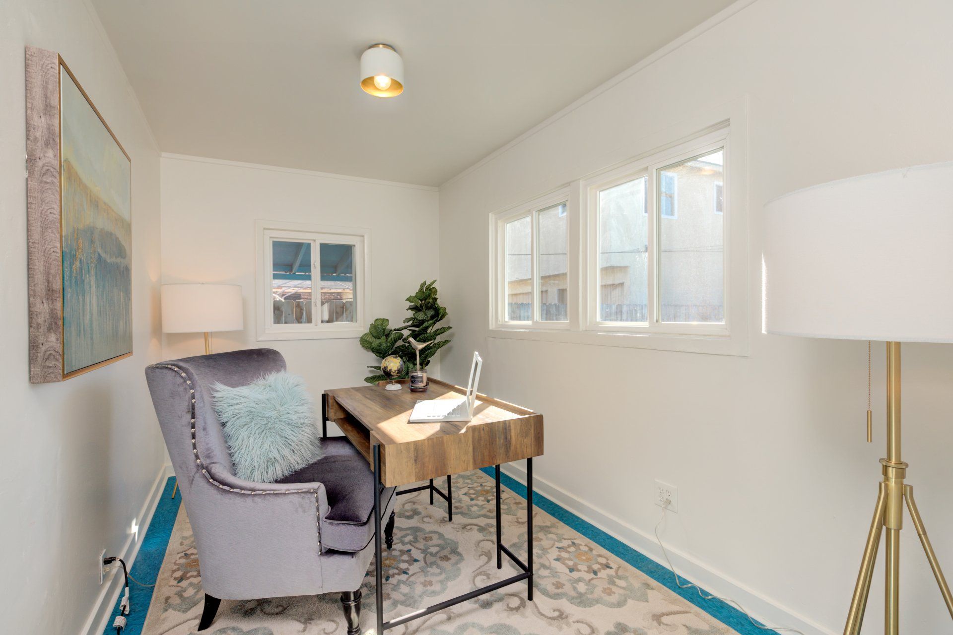 There is a chair and a desk in the room.