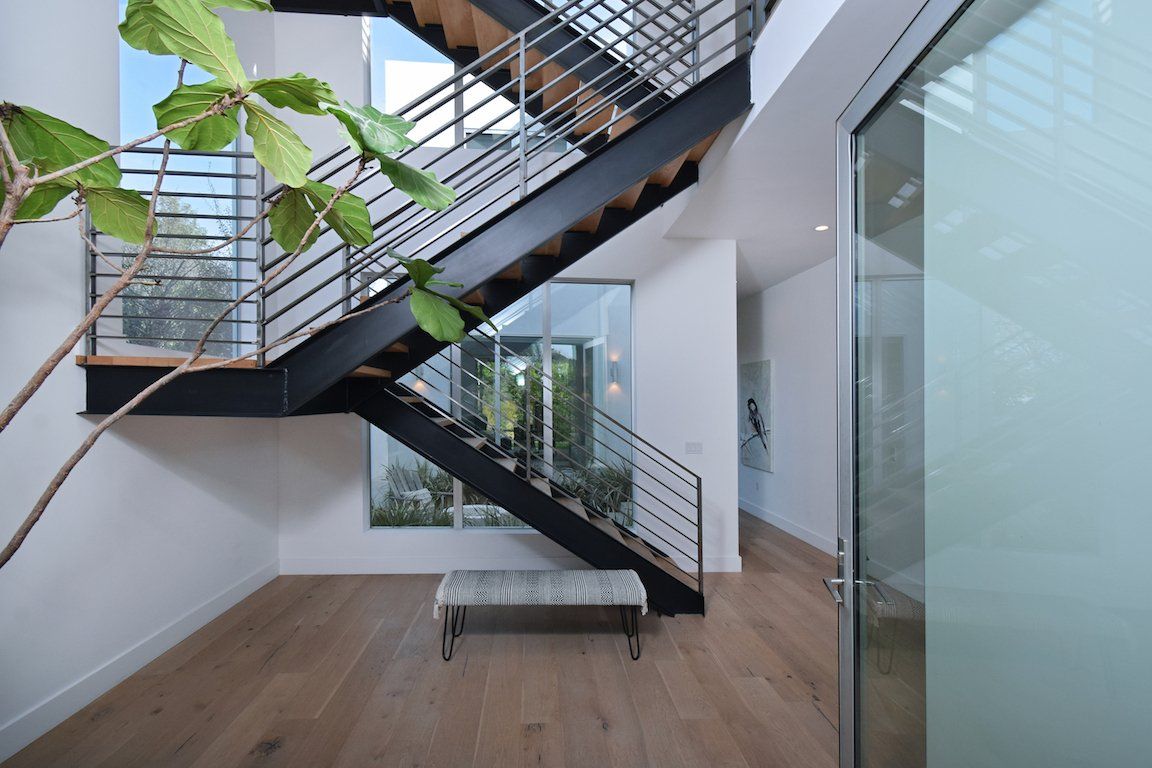 A staircase in a house with a bench underneath it