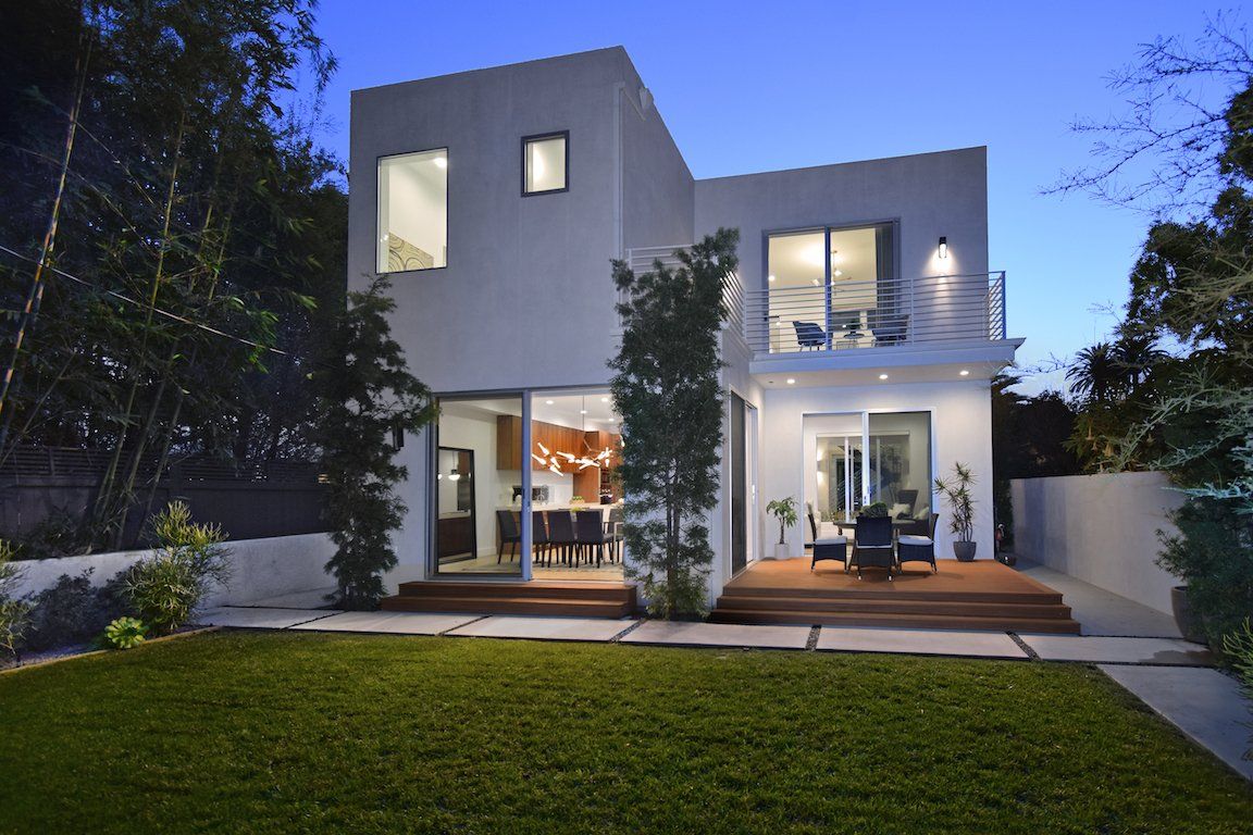 A modern house with a large lawn in front of it