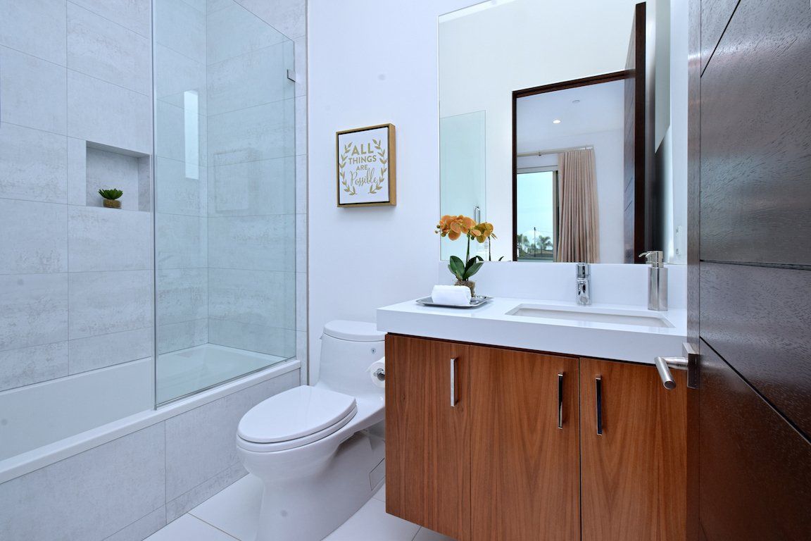A bathroom with a toilet , sink , and shower.