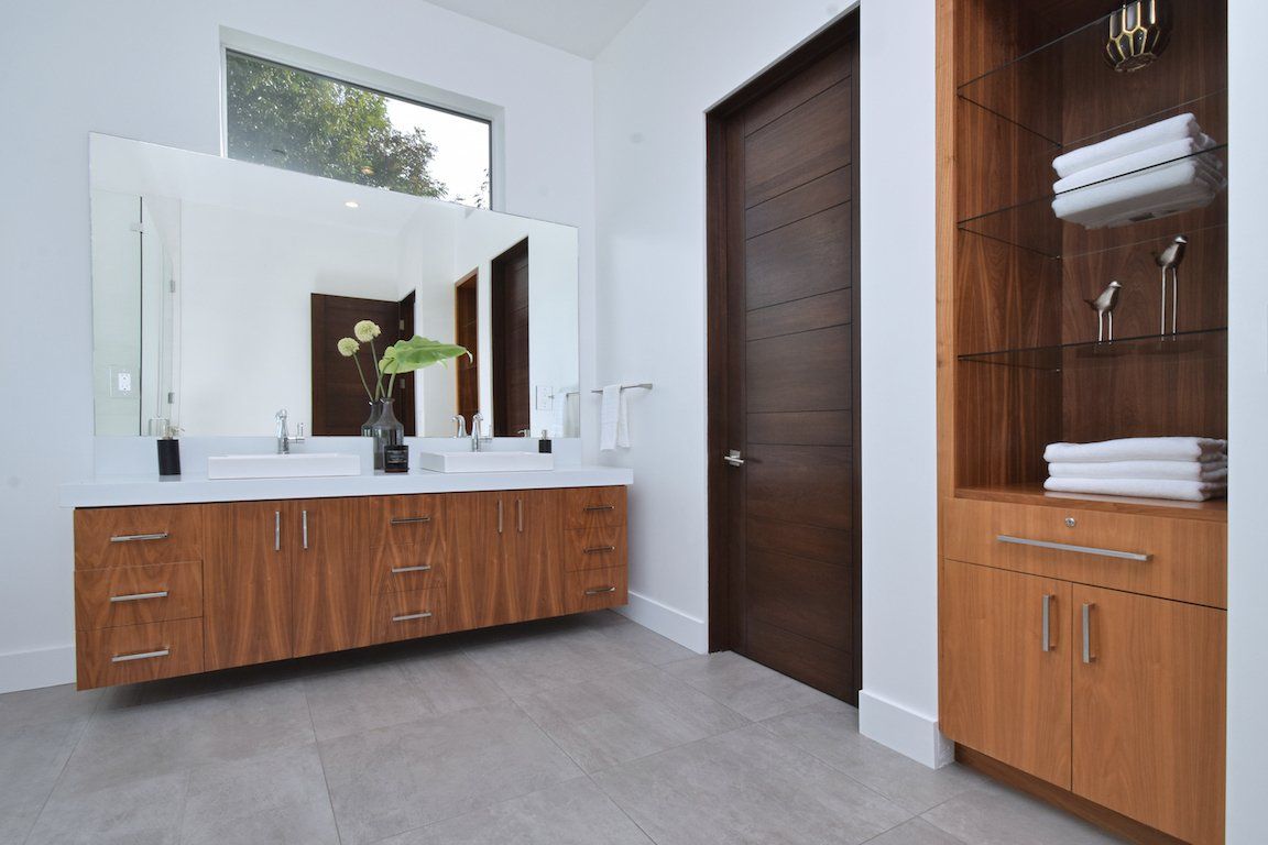 A bathroom with two sinks and a large mirror