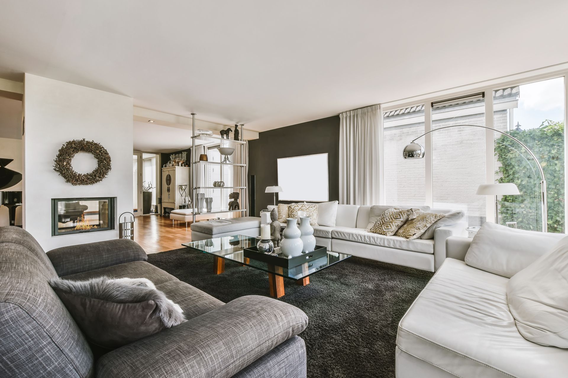 A living room with a couch , chair , coffee table and fireplace.