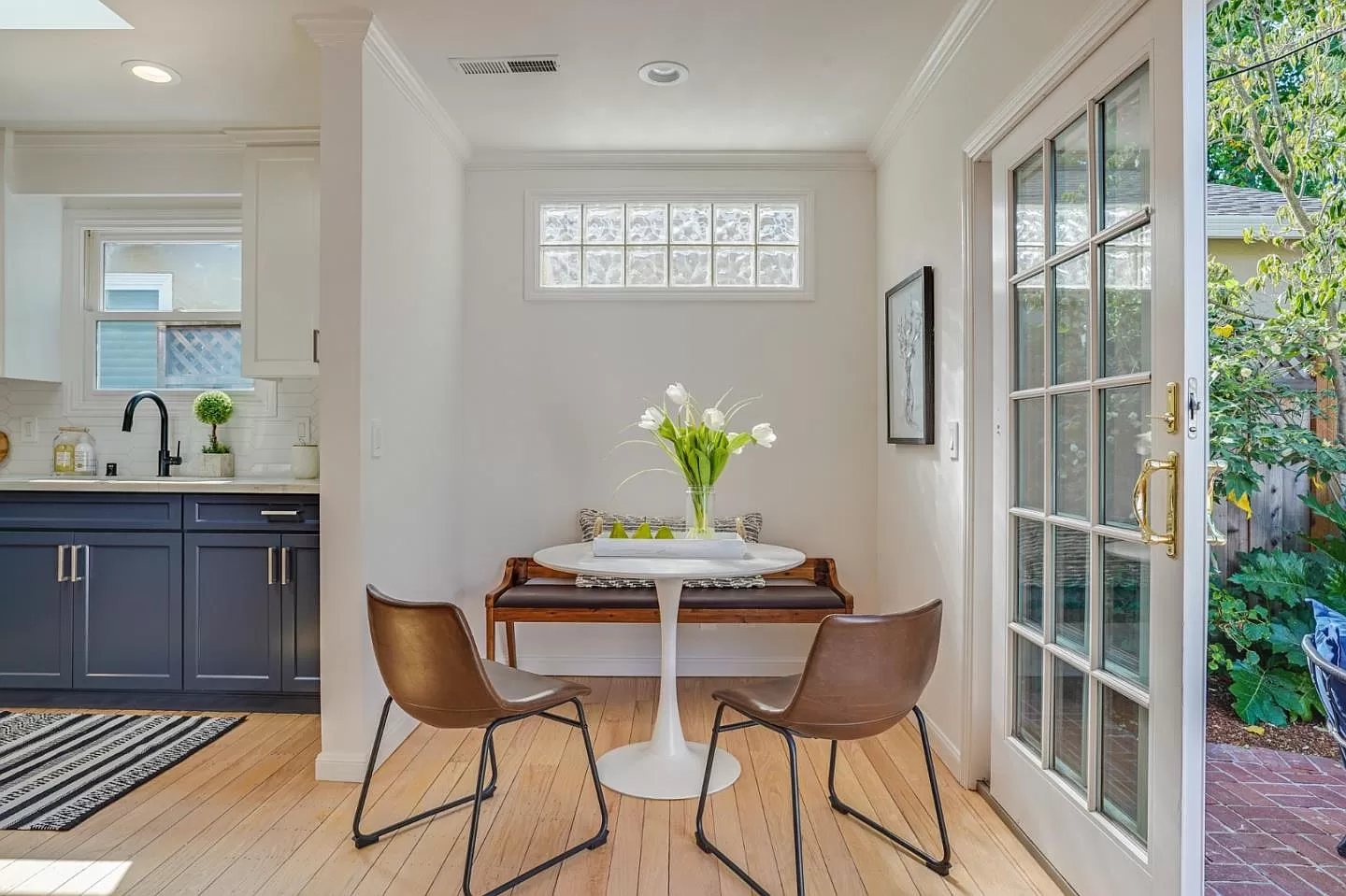 There is a table and chairs in the corner of the room.