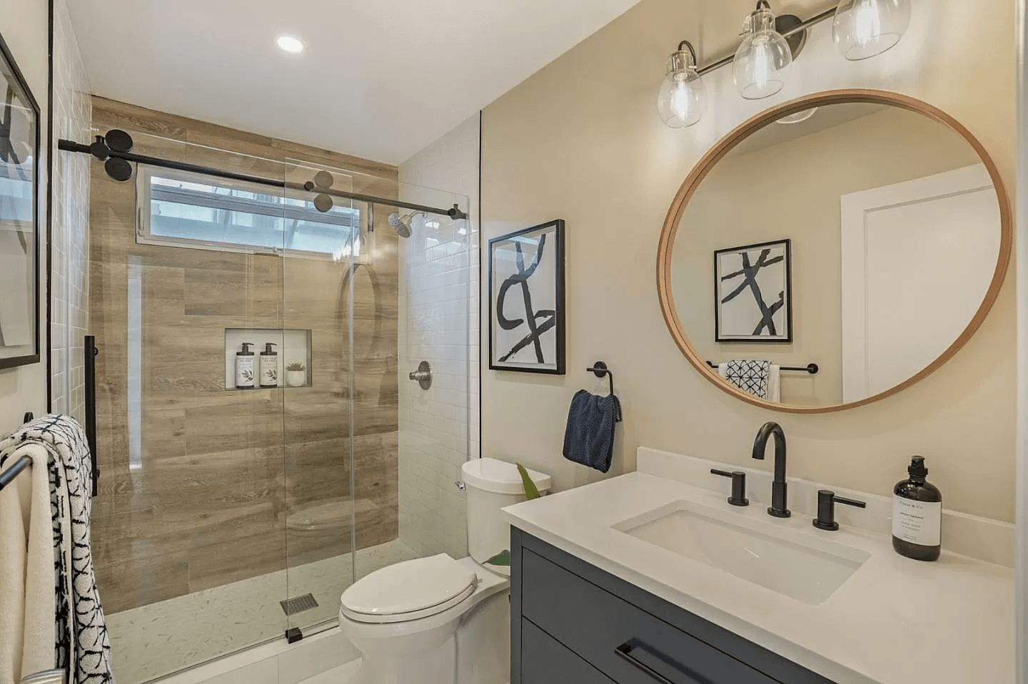 A bathroom with a toilet , sink , and shower.