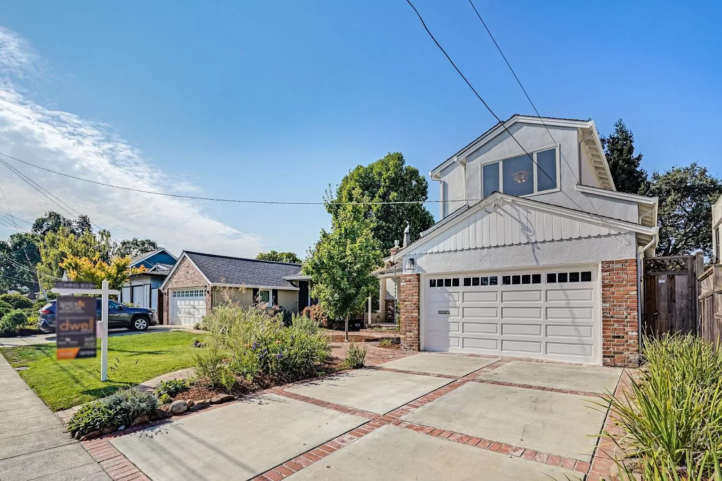 A house with a for sale sign in front of it
