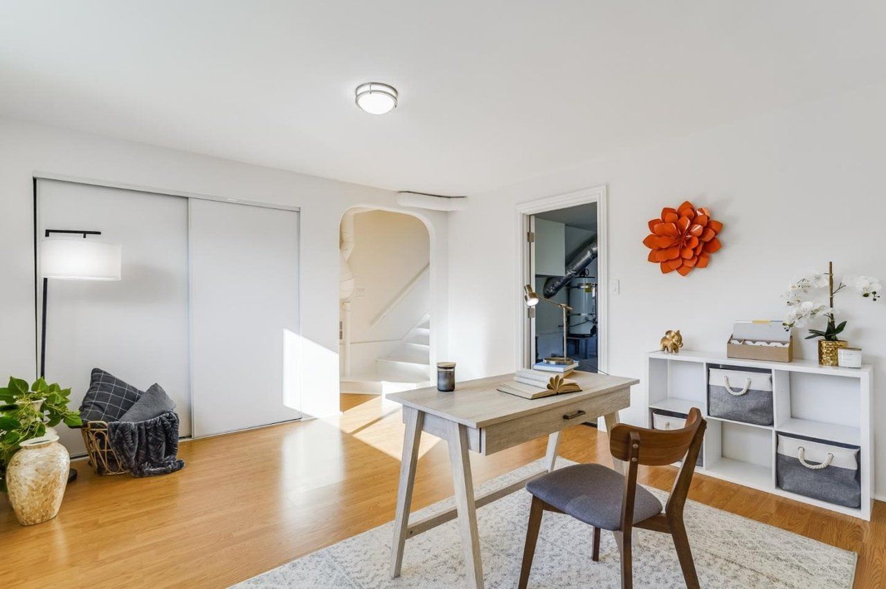 A room with a desk and chair in it.