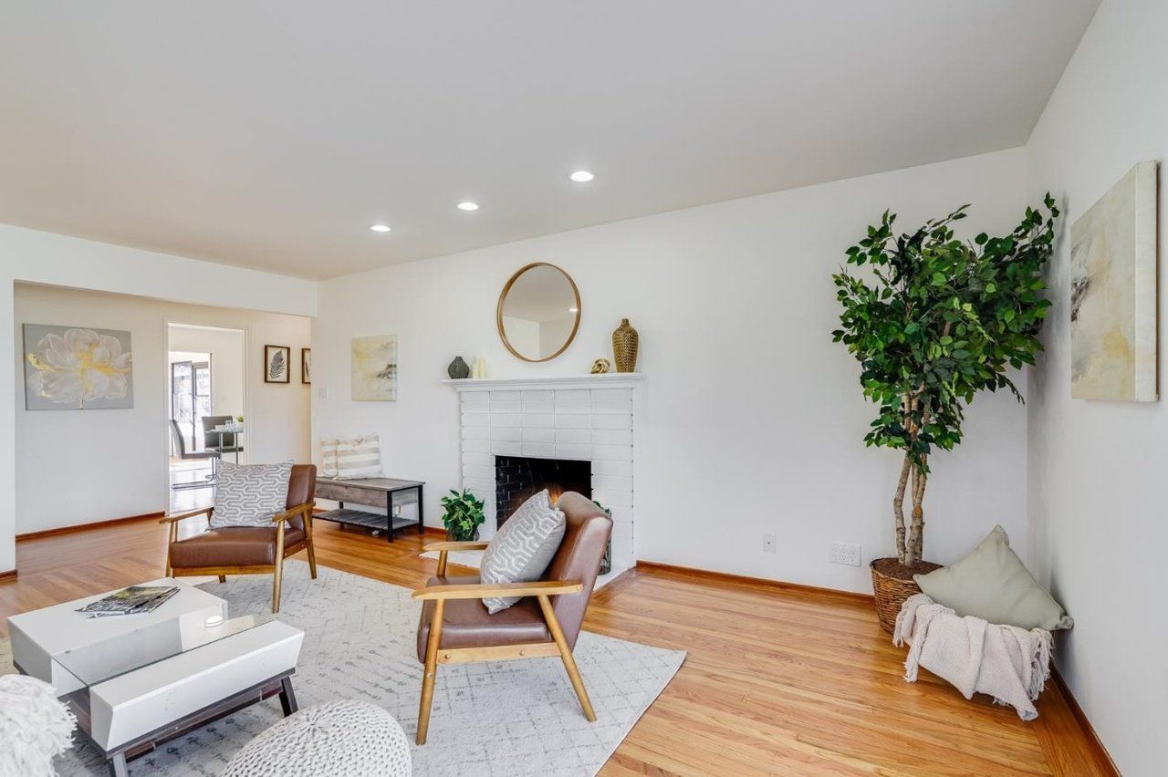 A living room filled with furniture and a fireplace.