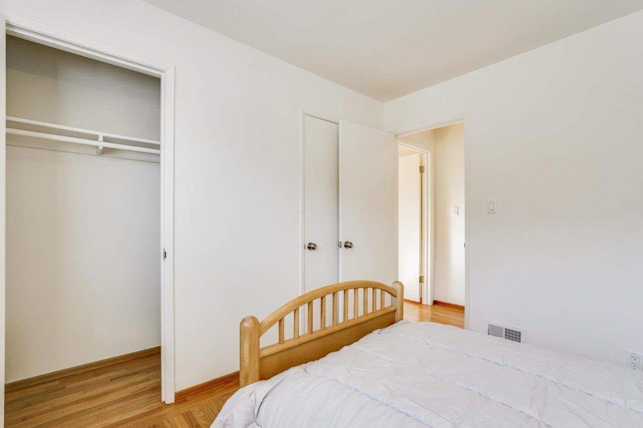 A bedroom with a bed and a closet.