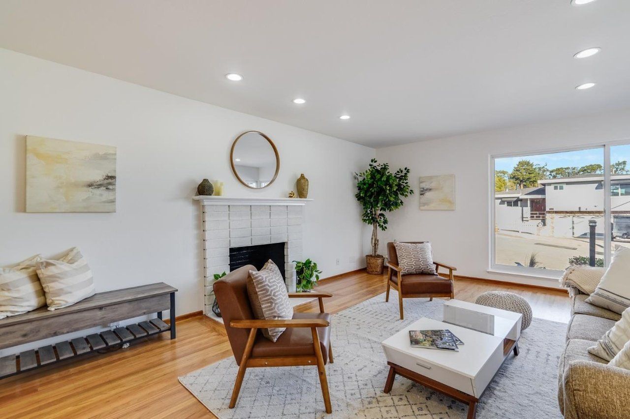 A living room filled with furniture and a fireplace.
